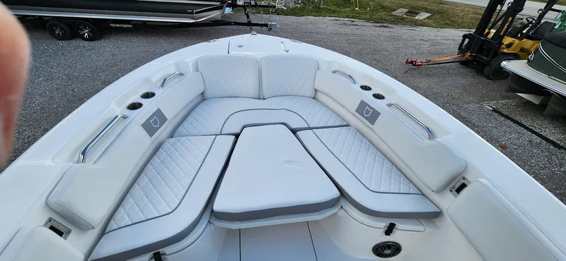 Slide: The Image of 2024 Sea Fox 248 Commander boat interior with cushioned seating and cup holders. - 12
