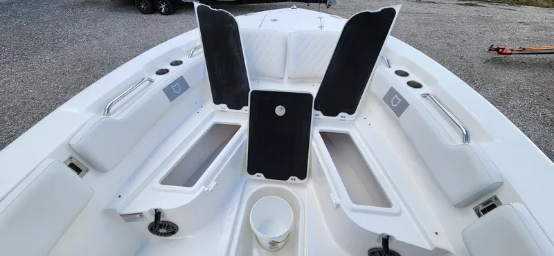 Slide: The Image of 2024 Sea Fox 248 Commander boat interior with open storage compartments and seating. - 14