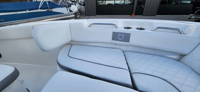 Slide: The Image of 2024 Sea Fox 248 Commander boat interior with white cushioned seating and cup holders. - 15