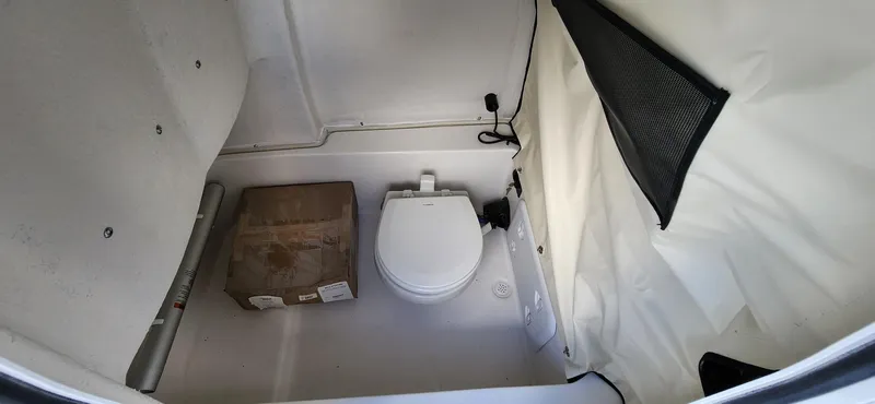 Slide: The Image of 2024 Sea Fox 248 Commander boat interior with toilet and storage area. - 16