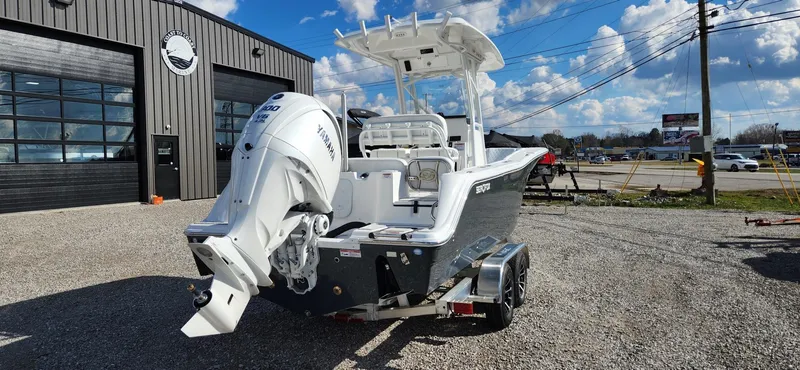 Slide: The Image of 2024 Sea Fox 248 Commander boat with Yamaha engine, parked outside a dealership. - 2