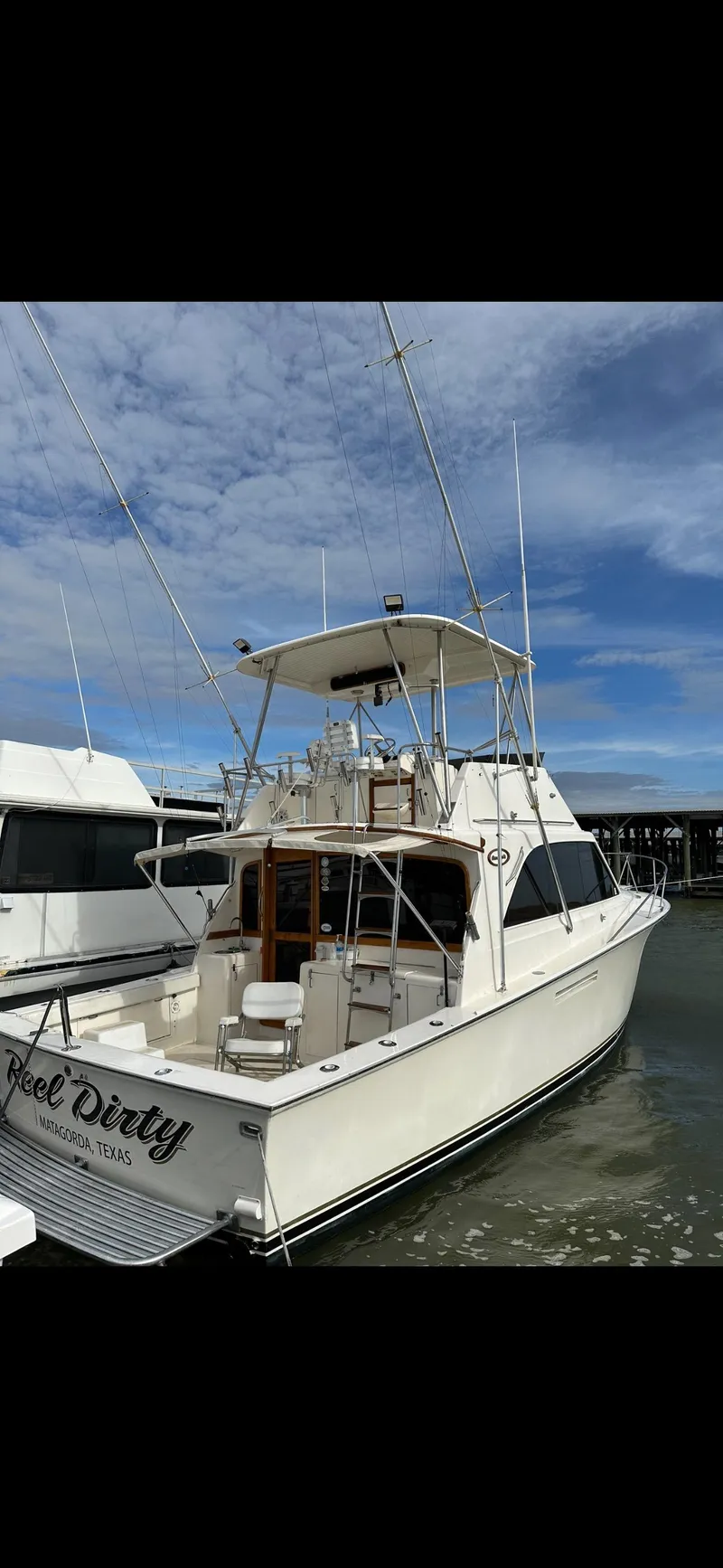 Slide: The Image of 1985 Ocean 38 Super Sport boat docked at marina. - 13