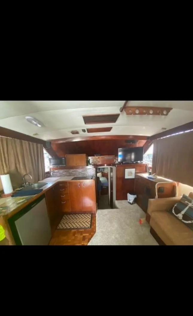 Slide: The Image of Interior of 1985 Ocean 38 Super Sport yacht with kitchen and seating area. - 20