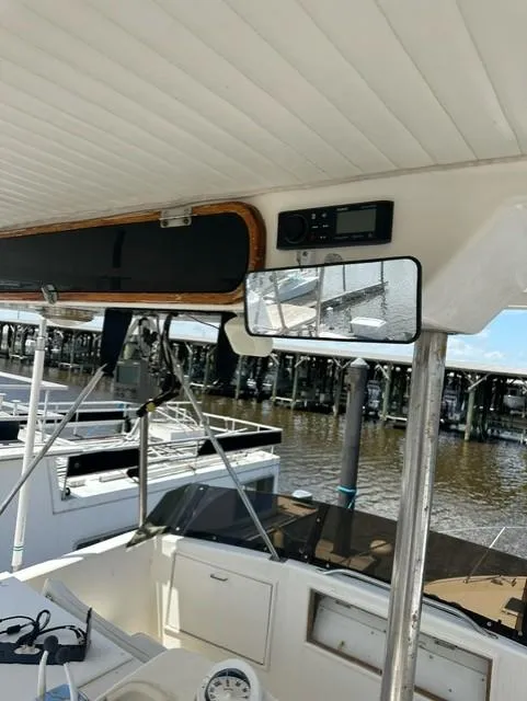 Slide: The Image of 1985 Ocean 38 Super Sport boat interior with dock view. - 26