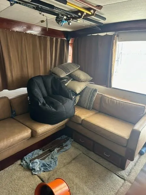 Slide: The Image of Interior of 1985 Ocean 38 Super Sport yacht with brown leather seating and fishing rods. - 27