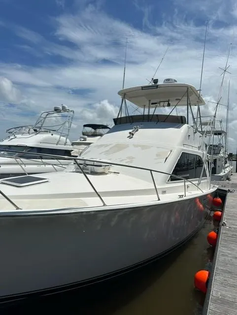 Slide: The Image of 1985 Ocean 38 Super Sport yacht docked at marina under blue sky. - 3