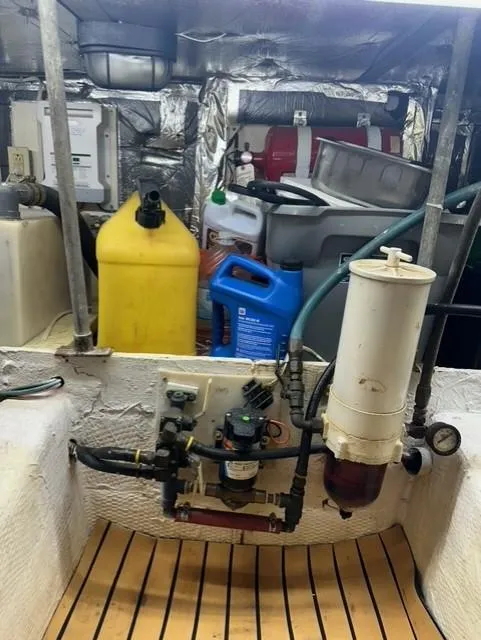 Slide: The Image of Engine room of a 1985 Ocean 38 Super Sport boat with various equipment and containers. - 31