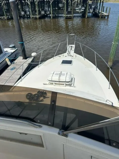 Slide: The Image of 1985 Ocean 38 Super Sport boat docked at a marina. - 32