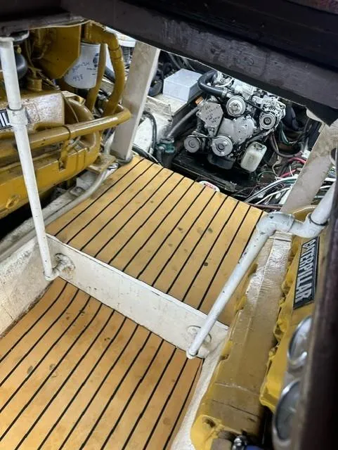 Slide: The Image of Engine room of a 1985 Ocean 38 Super Sport boat with wooden flooring. - 33