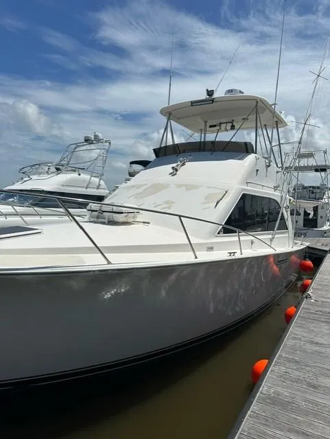 Slide: The Image of 1985 Ocean 38 Super Sport yacht docked at marina. - 39