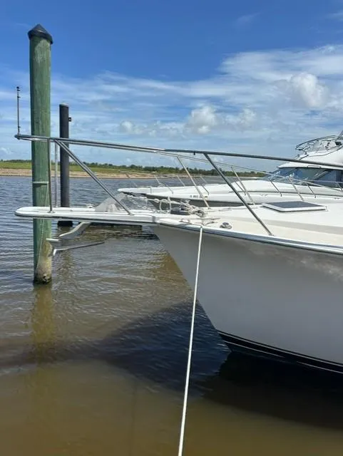 Slide: The Image of 1985 Ocean 38 Super Sport yacht docked at a marina. - 41
