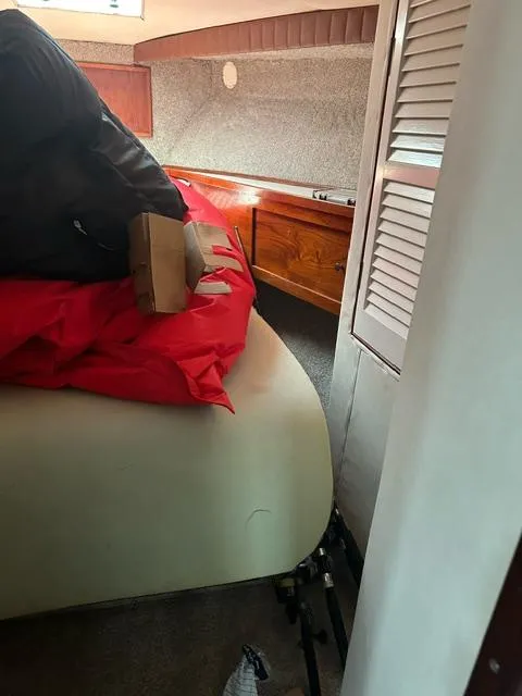 Slide: The Image of Interior cabin of a 1985 Ocean 38 Super Sport boat with bed and storage. - 45