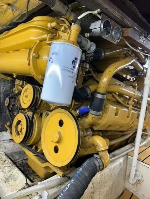 Slide: The Image of Engine of 1985 Ocean 38 Super Sport boat, featuring yellow components and filter. - 48