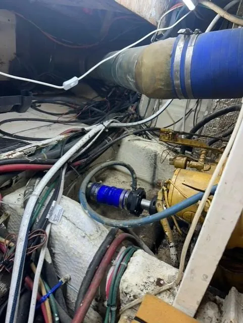 Slide: The Image of Engine compartment of a 1985 Ocean 38 Super Sport boat with various cables and hoses. - 50