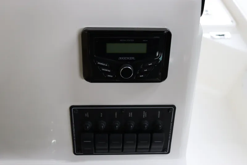 Slide: The Image of 2023 May-Craft 2200 Bay boat dashboard with radio and control panel. - 16