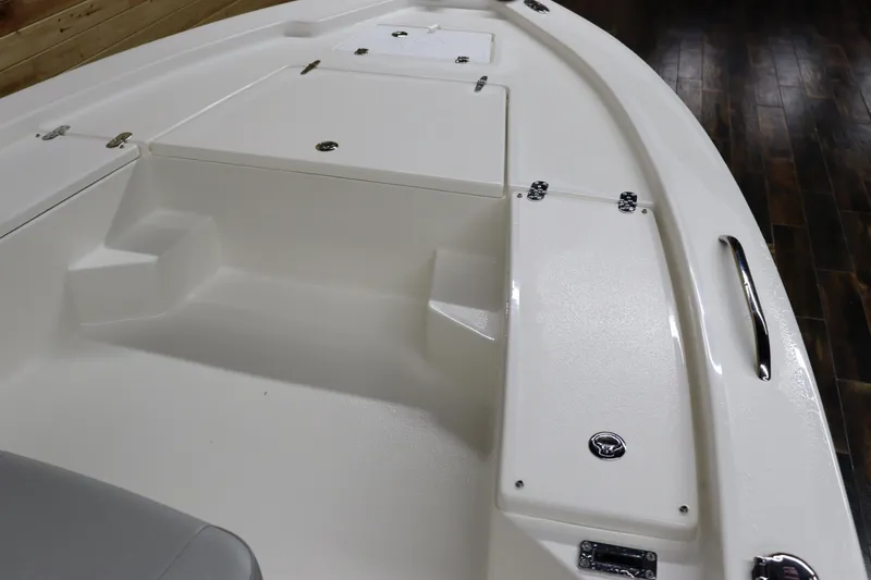 Slide: The Image of 2023 May-Craft 2200 Bay boat interior with storage compartments and seating. - 17