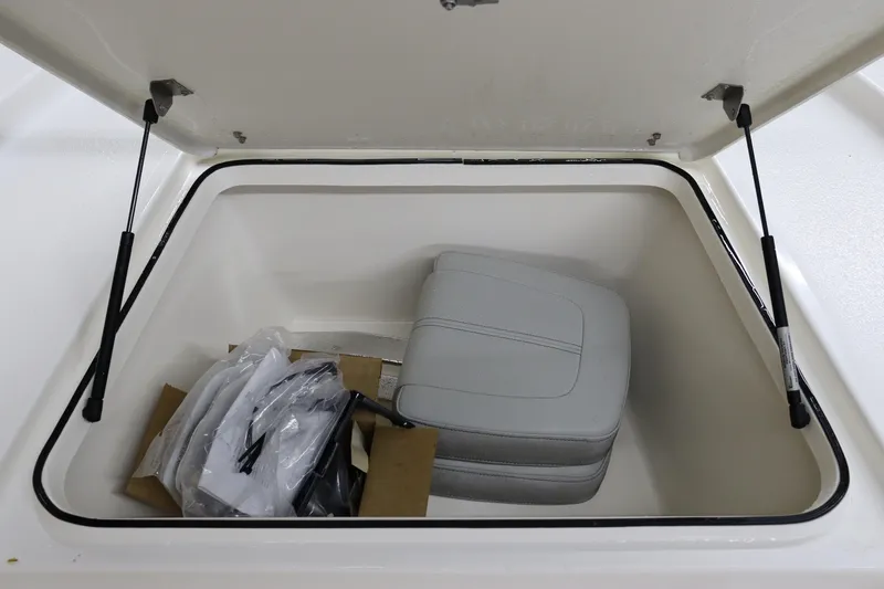 Slide: The Image of Open storage compartment in 2023 May-Craft 2200 Bay boat with seat cushion and accessories. - 19