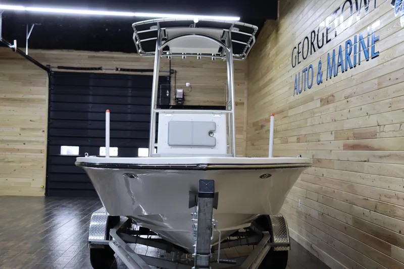 Slide: The Image of 2023 May-Craft 2200 Bay boat displayed indoors at Georgetown Auto & Marine. - 6