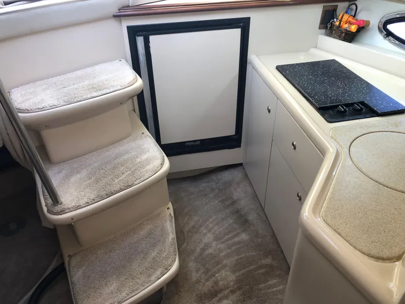 Slide: The Image of Interior of 2000 Cruisers Yachts 3375 Express with steps and kitchenette. - 11