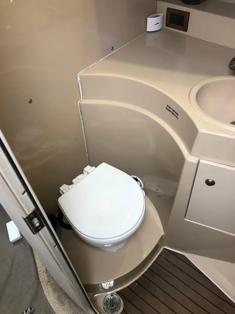Slide: The Image of 2000 Cruisers Yachts 3375 Express bathroom with toilet and sink. - 15