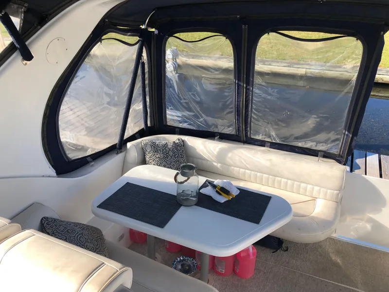 Slide: The Image of 2000 Cruisers Yachts 3375 Express interior with dining table and seating area. - 8