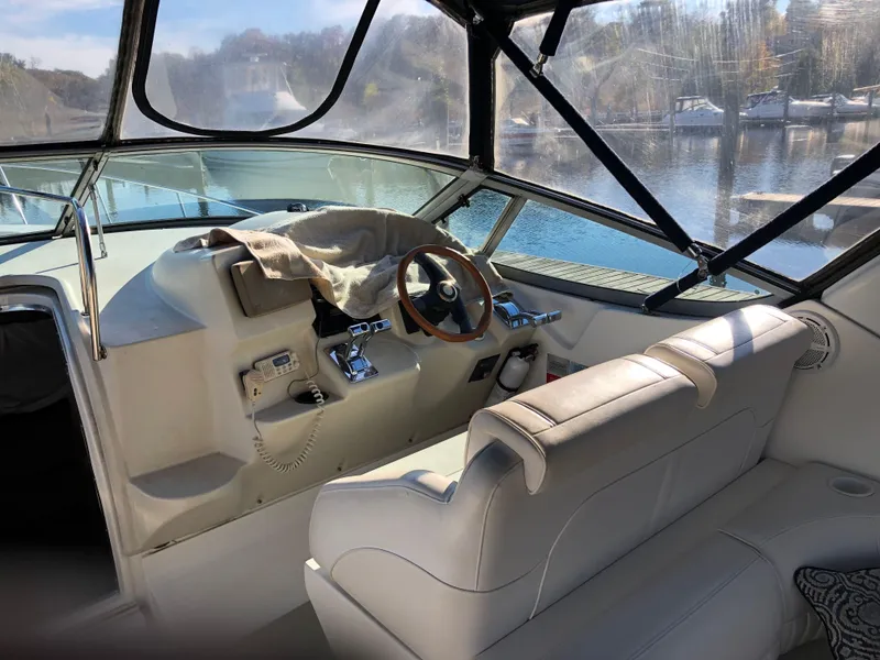 Slide: The Image of 2000 Cruisers Yachts 3375 Express helm with leather seating and wooden steering wheel. - 10