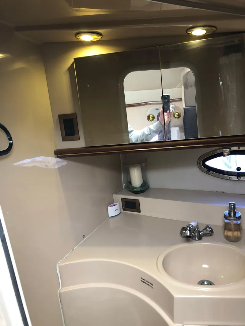 Slide: The Image of Bathroom vanity area in 2000 Cruisers Yachts 3375 Express with sink and mirror. - 16