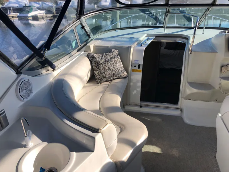 Slide: The Image of Interior of 2000 Cruisers Yachts 3375 Express with white seating and patterned cushion. - 9