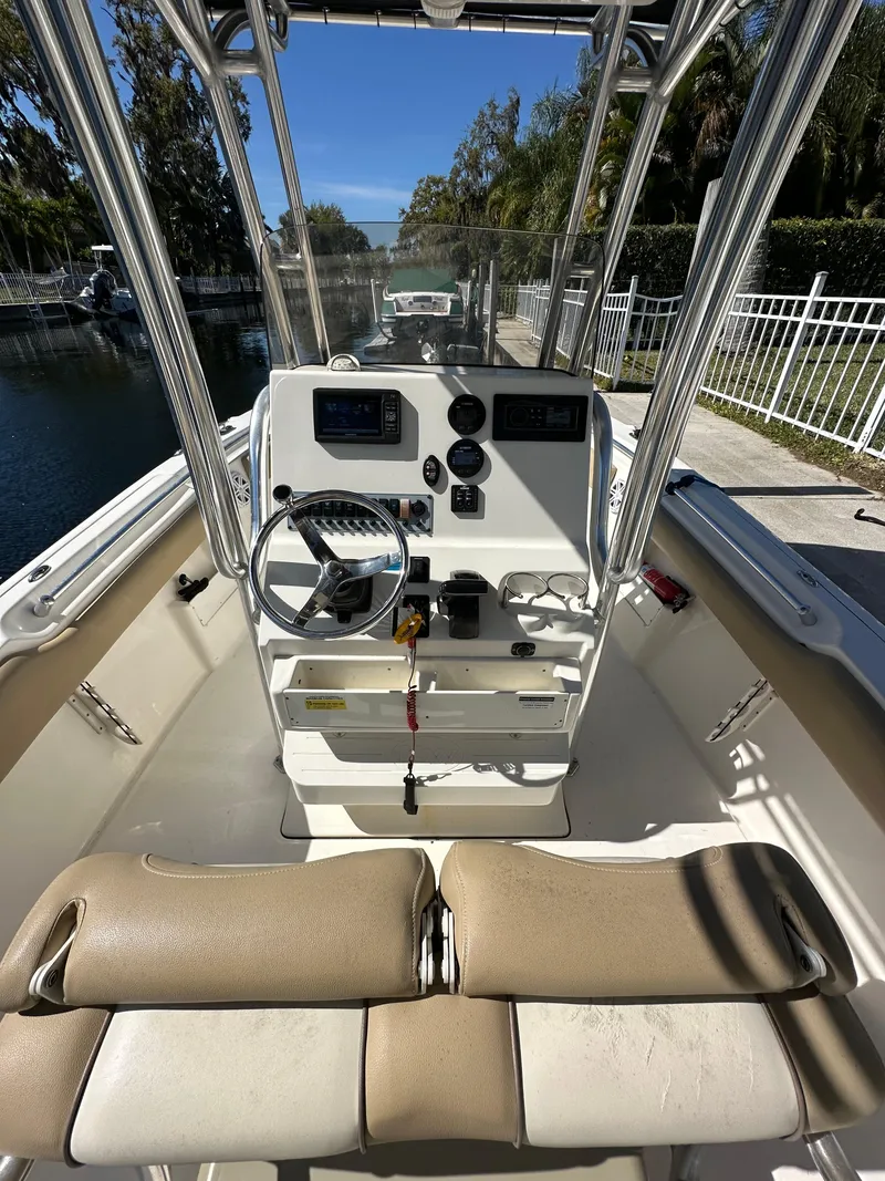 Slide: The Image of 2019 Key West 239 FS boat cockpit with steering wheel and control panel. - 10
