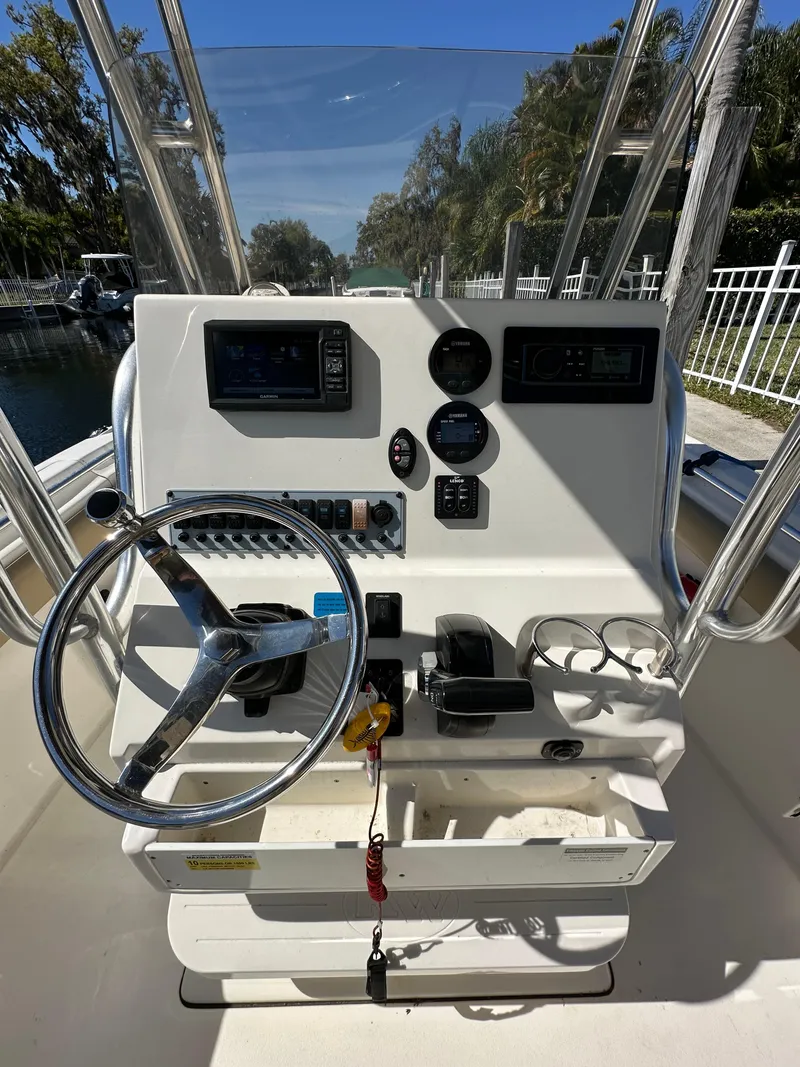 Slide: The Image of 2019 Key West 239 FS boat console with steering wheel and controls. - 11