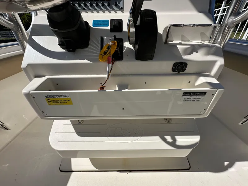 Slide: The Image of 2019 Key West 239 FS boat console with controls and storage compartment. - 15