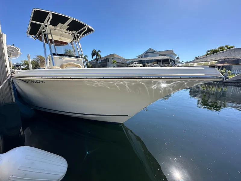 Slide: The Image of 2019 Key West 239 FS boat docked in a sunny marina. - 2