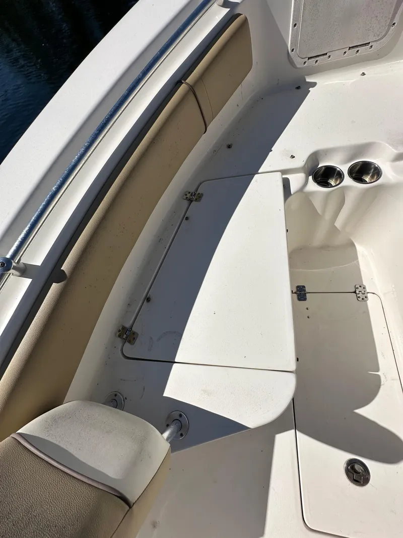 Slide: The Image of 2019 Key West 239 FS boat interior seating and storage compartments. - 21