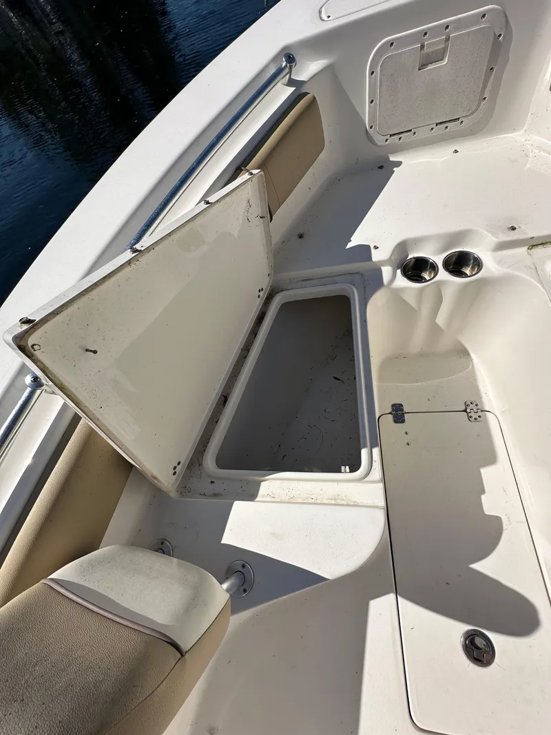 Slide: The Image of 2019 Key West 239 FS boat with open storage compartments. - 24