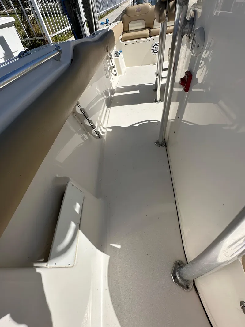 Slide: The Image of 2019 Key West 239 FS boat interior, showing seating and deck area. - 32