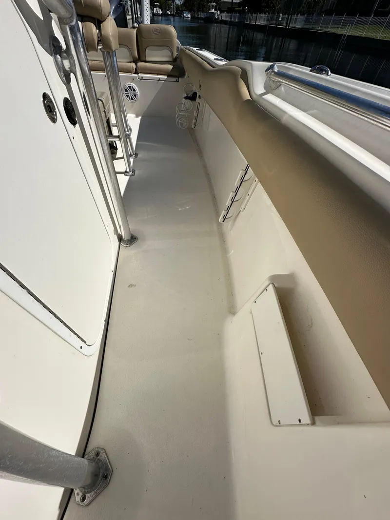 Slide: The Image of 2019 Key West 239 FS boat interior walkway with beige seating. - 33