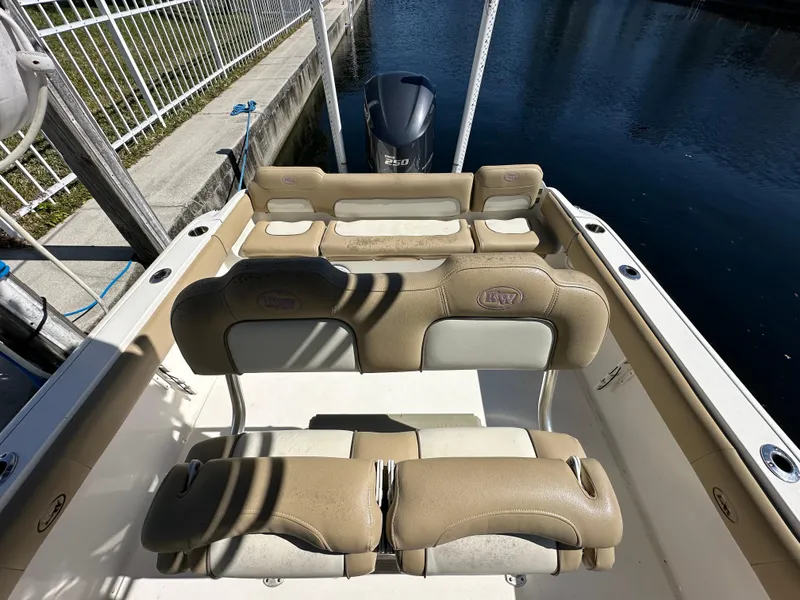 Slide: The Image of 2019 Key West 239 FS boat interior with tan seating and Yamaha outboard motor. - 34