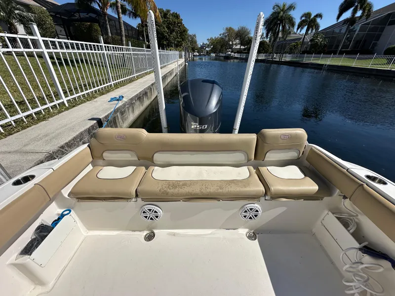 Slide: The Image of 2019 Key West 239 FS boat with seating and Yamaha 250 engine, docked by a canal. - 35
