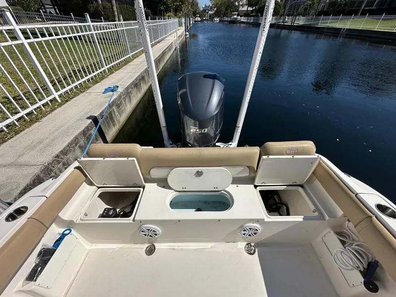 Slide: The Image of 2019 Key West 239 FS boat stern with Yamaha 250 engine docked by canal. - 36