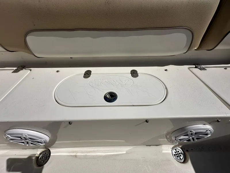 Slide: The Image of 2019 Key West 239 FS boat interior with storage compartment and speakers. - 38