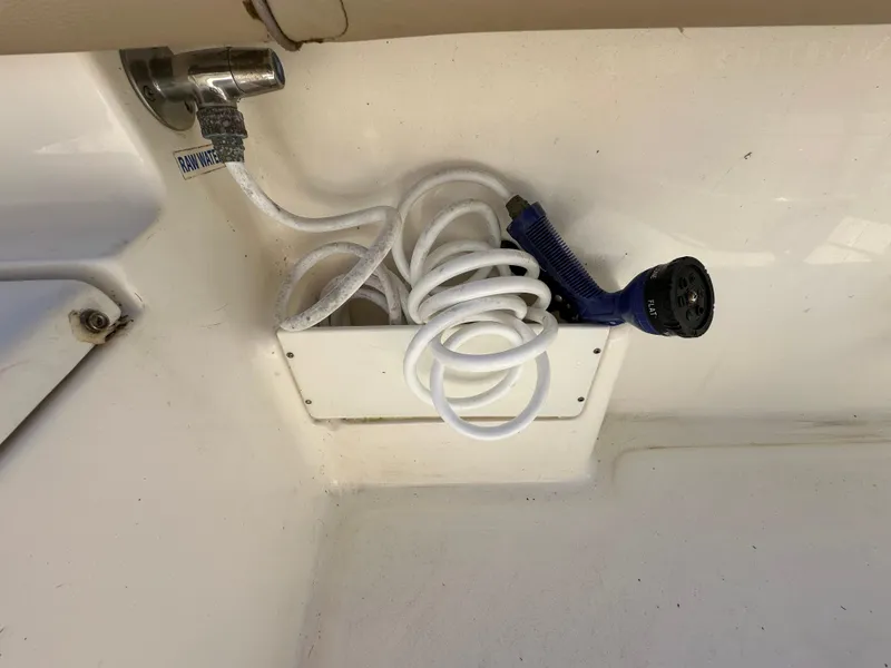 Slide: The Image of 2019 Key West 239 FS boat with coiled hose and spray nozzle. - 43