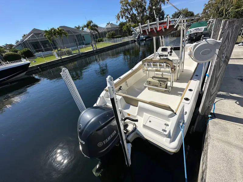 Slide: The Image of 2019 Key West 239 FS boat docked in a canal with Yamaha outboard motor. - 6