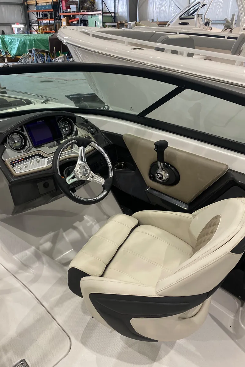 Slide: The Image of 2024 Monterey 215SS boat interior with steering wheel and dashboard. - 14