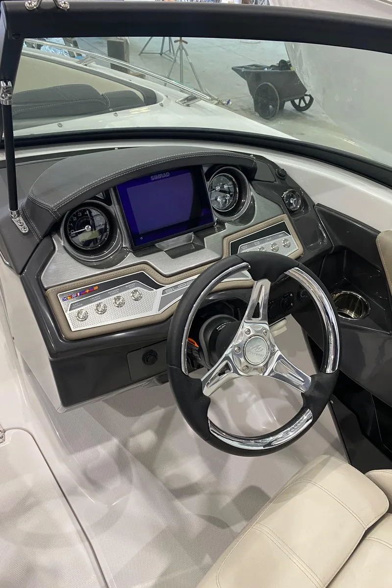 Slide: The Image of 2024 Monterey 215SS boat dashboard with steering wheel and digital display. - 15