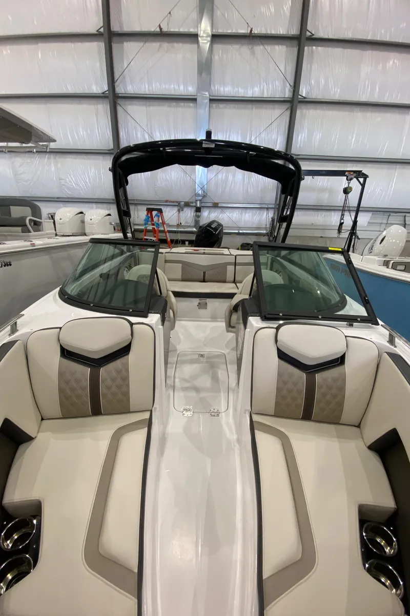 Slide: The Image of 2024 Monterey 215SS boat interior with luxurious seating in a showroom. - 16