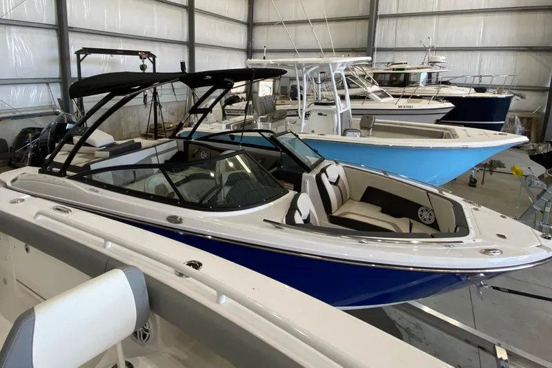 Slide: The Image of 2024 Monterey 215SS boat in indoor storage, featuring sleek design and modern amenities. - 18