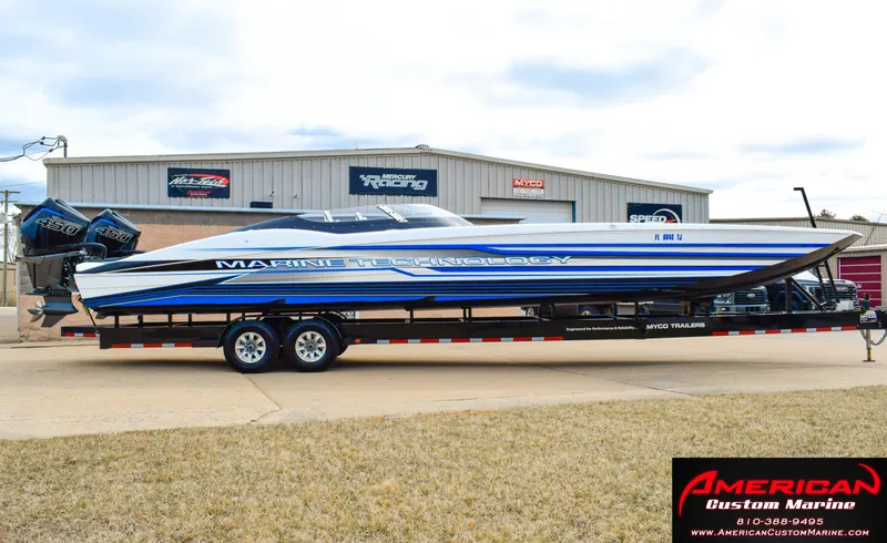 The Image of 2022 MTI 390X boat on trailer in front of workshop. - 1