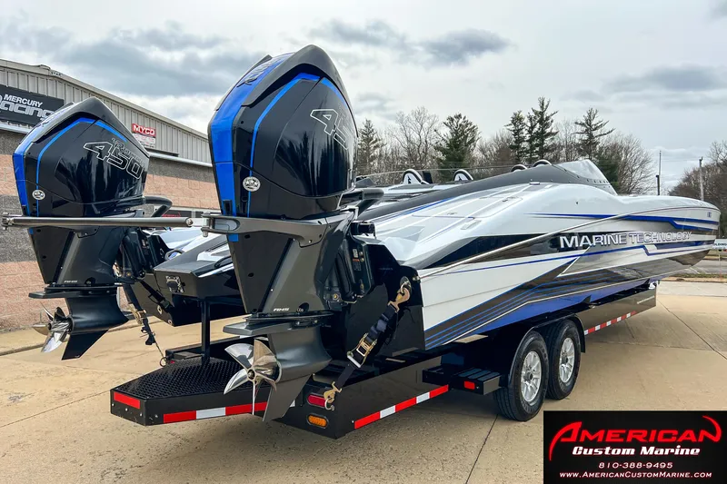 Slide: The Image of MTI 390X 2022 boat with dual outboard engines on trailer. - 11