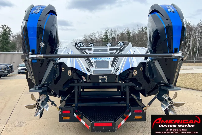 Slide: The Image of Rear view of a 2022 MTI 390X boat with dual engines. - 12