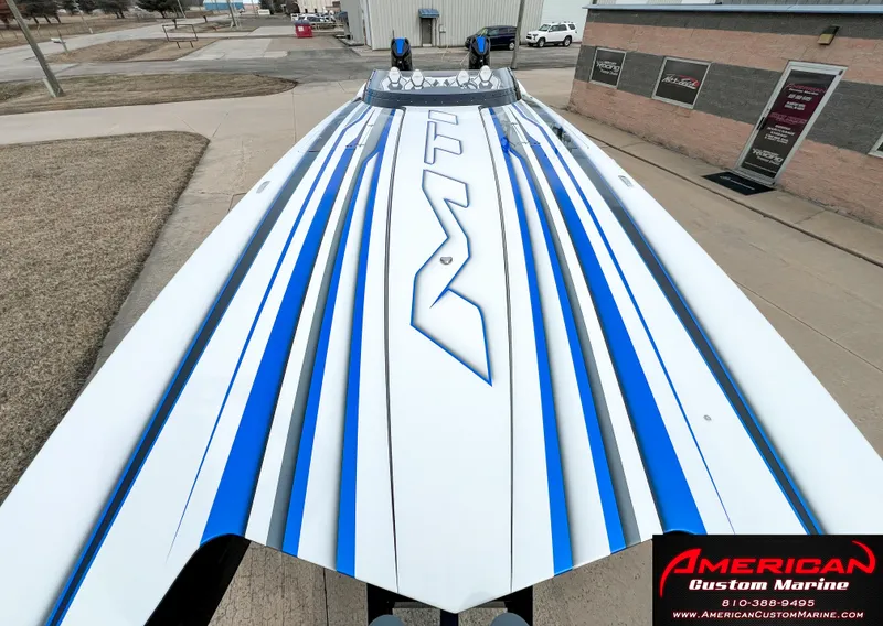 Slide: The Image of 2022 MTI 390X boat with blue and white stripe design, American Custom Marine. - 25